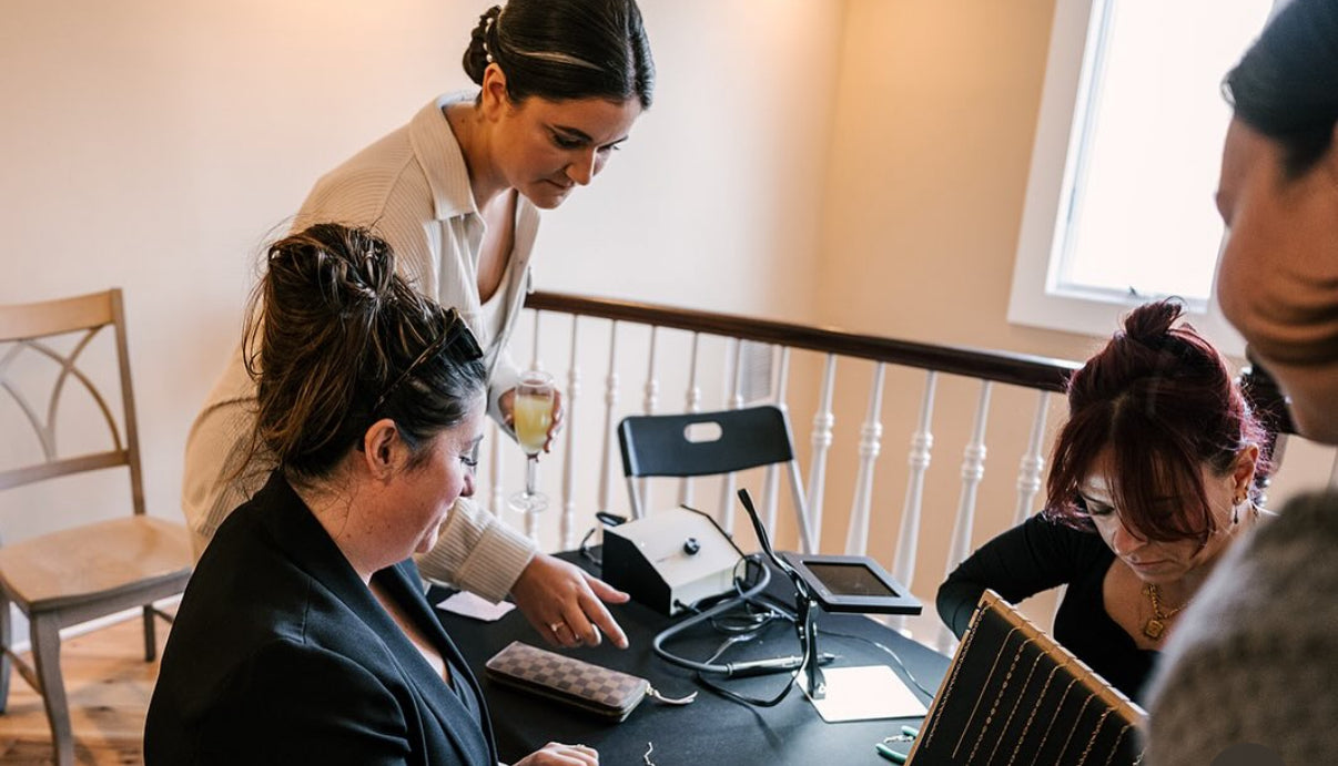 Two women selecting their chains for their Permanent Jewelry Experience